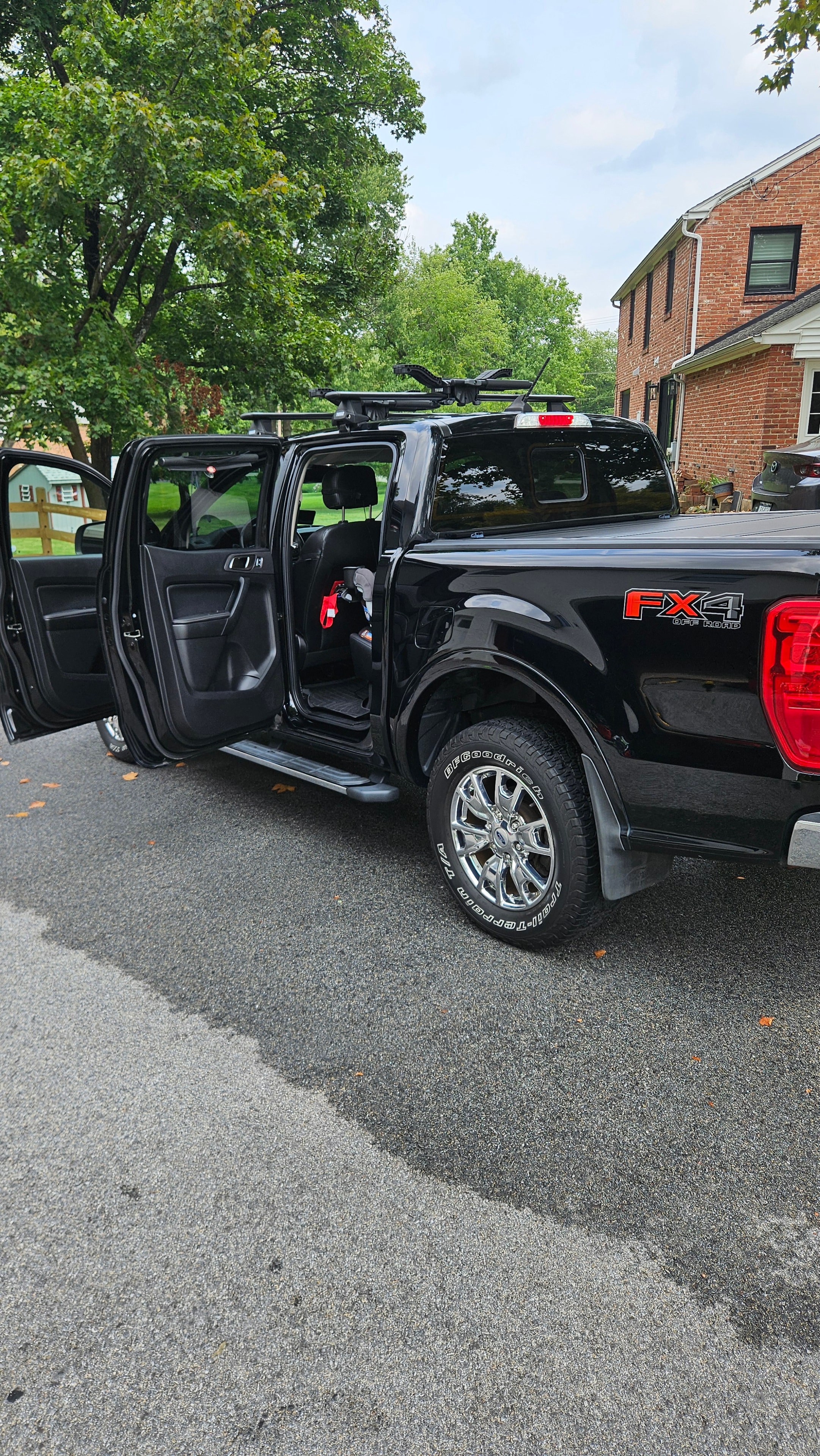 Black Ford pickup with open doors